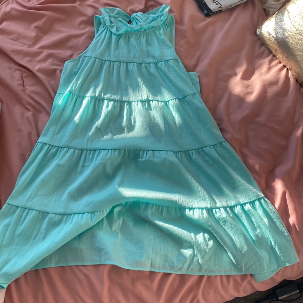 Teal ruffled dress with bow in the back.